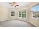 Bedroom featuring neutral walls, ceiling fan, and two large windows at 104 Shady Ridge Ct, Apex, NC 27502