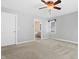 Spacious bedroom featuring plush carpet, neutral walls, and a view of an en-suite bathroom at 104 Shady Ridge Ct, Apex, NC 27502