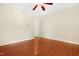 A bedroom with hardwood floors, ceiling fan, cream walls, and white trim at 104 Shady Ridge Ct, Apex, NC 27502