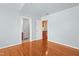 Bright bedroom featuring hardwood floors and an open doorway to an adjacent room at 104 Shady Ridge Ct, Apex, NC 27502