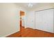 Cozy bedroom featuring hardwood floors, a ceiling fan, and an open doorway to the kitchen at 104 Shady Ridge Ct, Apex, NC 27502