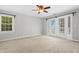 Neutral bedroom with wall-to-wall carpet, large window, and sliding glass doors at 104 Shady Ridge Ct, Apex, NC 27502