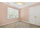 Cozy bedroom with neutral carpet, double door closet, and a window, creating a tranquil retreat at 104 Shady Ridge Ct, Apex, NC 27502