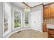 This is a breakfast nook with tile floors, white walls, a window, and a wooden cabinet at 104 Shady Ridge Ct, Apex, NC 27502