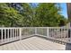Outdoor deck with a white railing overlooking lush green trees at 104 Shady Ridge Ct, Apex, NC 27502