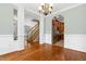 Elegant dining room featuring hardwood floors, wainscoting, chandelier, and open floor plan at 104 Shady Ridge Ct, Apex, NC 27502