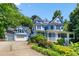 Charming two-story home with light blue siding, white trim, front porch, and an attached two car garage at 104 Shady Ridge Ct, Apex, NC 27502