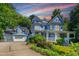 Stunning Victorian-style home in light blue, enhanced by lush landscaping and a wide driveway at 104 Shady Ridge Ct, Apex, NC 27502