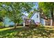 Two-story home featuring a deck, screened porch, and spacious backyard with mature trees at 104 Shady Ridge Ct, Apex, NC 27502