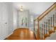 Bright foyer with hardwood floors, staircase, white trim, and natural light streaming through the front door at 104 Shady Ridge Ct, Apex, NC 27502