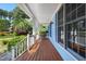 Inviting front porch with stained wood flooring, blue siding, white railing, and ample space for relaxing at 104 Shady Ridge Ct, Apex, NC 27502