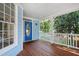 Inviting front porch with stained wood flooring, blue siding, white railing, and ample space for relaxing at 104 Shady Ridge Ct, Apex, NC 27502