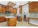 This is a full kitchen view with wood cabinets, a kitchen island, stainless steel appliances, and tile backsplash at 104 Shady Ridge Ct, Apex, NC 27502