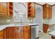 This is a close-up view of the kitchen with wooden cabinets, stainless steel appliances, and a tile backsplash at 104 Shady Ridge Ct, Apex, NC 27502