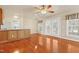 Open-concept living area with hardwood floors, connecting seamlessly to a dining area with patio doors at 104 Shady Ridge Ct, Apex, NC 27502