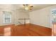 Cozy room featuring hardwood floors, a ceiling fan, and stairs leading to the upper level at 104 Shady Ridge Ct, Apex, NC 27502