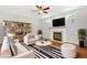 Cozy staged living room with fireplace and custom shelving at 104 Shady Ridge Ct, Apex, NC 27502