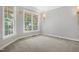Cozy living room with neutral walls, carpet, and large windows offering plenty of natural light at 104 Shady Ridge Ct, Apex, NC 27502