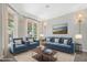 Bright living room featuring plush blue sofas and armchairs, perfect for relaxing and entertaining guests at 104 Shady Ridge Ct, Apex, NC 27502