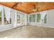 This sun room has wood paneling, lots of windows, and a set of french doors to the backyard at 104 Shady Ridge Ct, Apex, NC 27502