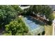 Aerial view of a blue and green tennis court with trees, green space and a residential building at 104 Shady Ridge Ct, Apex, NC 27502