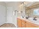 Bathroom featuring double sinks, granite countertops, and a tile shower, offering a luxurious and functional space at 104 Trinity Grove Dr, Cary, NC 27513