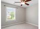 Cozy bedroom with carpet flooring, a ceiling fan, and a window with blinds providing natural light and ventilation at 104 Trinity Grove Dr, Cary, NC 27513