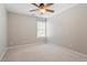 Comfortable bedroom with carpet flooring, a ceiling fan, and ample natural light, creating a relaxing atmosphere at 104 Trinity Grove Dr, Cary, NC 27513