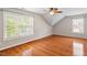 Bright bedroom with hardwood floors, ceiling fan, and natural light from two large windows at 104 Trinity Grove Dr, Cary, NC 27513