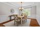 Bright dining room featuring hardwood floors, decorative chandelier and window at 104 Trinity Grove Dr, Cary, NC 27513