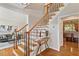 Elegant foyer with hardwood floors, staircase, and views of the living room at 104 Trinity Grove Dr, Cary, NC 27513