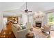 Bright living room with fireplace, hardwood floors and view of the kitchen at 104 Trinity Grove Dr, Cary, NC 27513