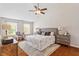 Spacious main bedroom with hardwood floors, ceiling fan, and large windows offering plenty of natural light at 104 Trinity Grove Dr, Cary, NC 27513