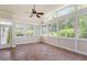 Bright sunroom with tile floors, large windows, and ceiling fan, perfect for relaxing and enjoying the view at 104 Trinity Grove Dr, Cary, NC 27513