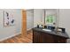 Bathroom showcasing a dark vanity with a granite countertop and framed mirror at 106 Choptank Ct # B-2, Cary, NC 27513