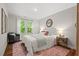 Cozy bedroom with a large window, plush rug, and stylish furnishings for relaxation at 106 Choptank Ct # B-2, Cary, NC 27513