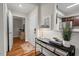 Bright foyer with wood floors, black console table with decor, and entry to the kitchen at 106 Choptank Ct # B-2, Cary, NC 27513