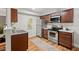 A bright kitchen boasts stainless steel appliances, dark wood cabinetry, and durable flooring at 106 Choptank Ct # B-2, Cary, NC 27513