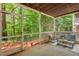 Screened porch with wooded views, outdoor seating, and concrete floors at 106 Choptank Ct # B-2, Cary, NC 27513