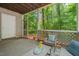 Screened porch showcasing outdoor seating, wooded views, and concrete flooring at 106 Choptank Ct # B-2, Cary, NC 27513
