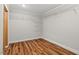Walk-in closet featuring wood-look floors and installed white wire shelving at 106 Choptank Ct # B-2, Cary, NC 27513