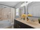 Spacious bathroom featuring a double vanity, tub, and shower with modern fixtures at 1104 Pebblestone Drive, Durham, NC 27703