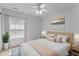 Bright bedroom with natural light, ceiling fan, neutral walls, and wood accents at 1104 Pebblestone Drive, Durham, NC 27703