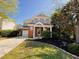 Charming two-story home featuring a brick facade, manicured lawn, and attached garage at 1104 Pebblestone Drive, Durham, NC 27703