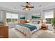 Spacious main bedroom with a tray ceiling, ceiling fan, and large windows providing natural light at 1104 Pebblestone Drive, Durham, NC 27703