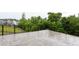 Spacious stamped concrete patio features elegant black metal railing and views of the wooded backyard at 112 Bellmont Crest Dr, Holly Springs, NC 27540