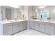 Dual sink bathroom with marble floors, gray vanities and great lighting at 112 Bellmont Crest Dr, Holly Springs, NC 27540