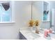 Well-lit bathroom with modern vanity, decorative vase with flowers, and an electric outlet at 112 Bellmont Crest Dr, Holly Springs, NC 27540