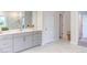 Bright bathroom with double vanity, marble floors, and glass-enclosed shower at 112 Bellmont Crest Dr, Holly Springs, NC 27540