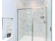 Bathroom featuring a sleek glass shower and a shower head, complete with elegant marble tiling at 112 Bellmont Crest Dr, Holly Springs, NC 27540